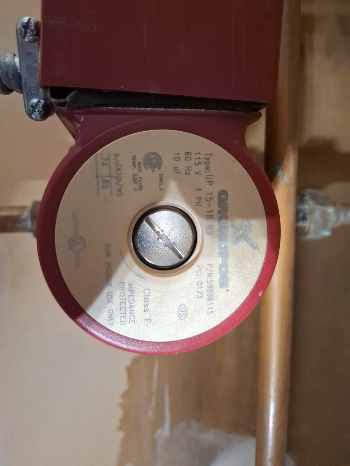 Close-up of the nameplate on a Grundfos UP 15-18 B5 circulator pump showing its 115-volt rating